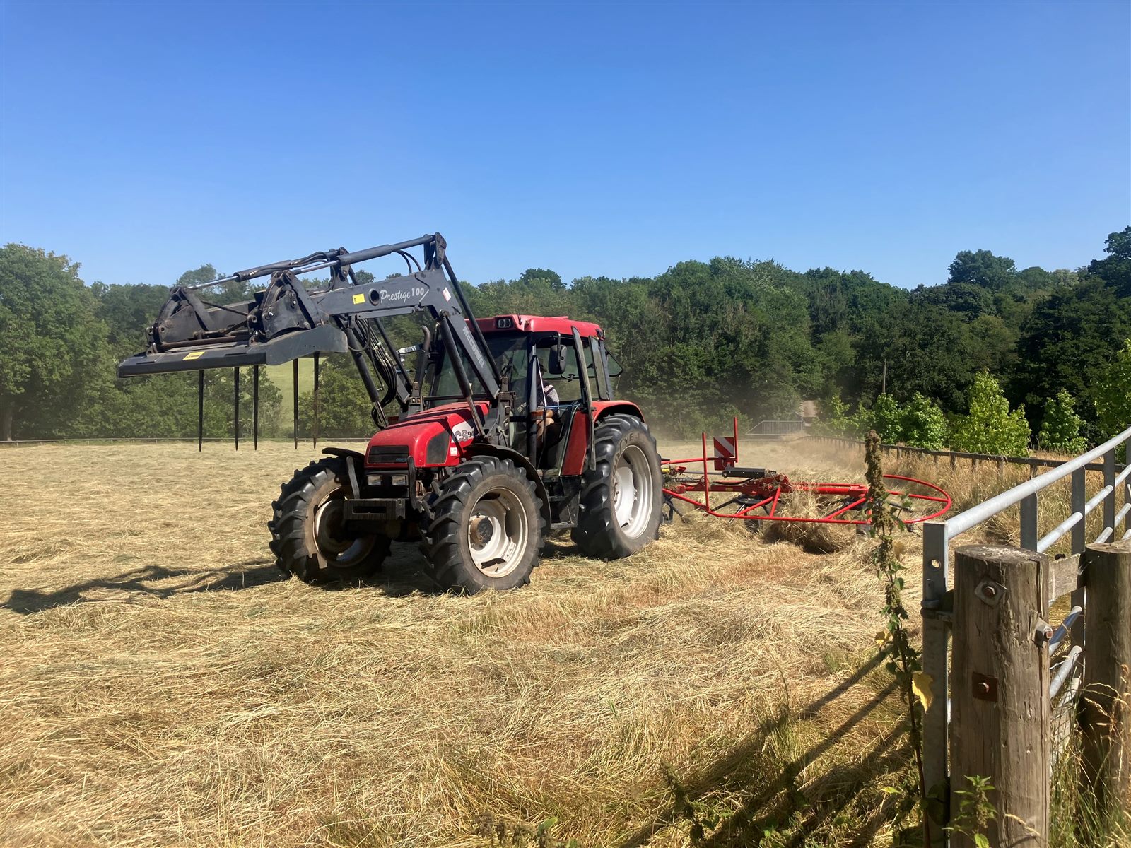 Tractor turning hay in the fields at Reaside Farm
